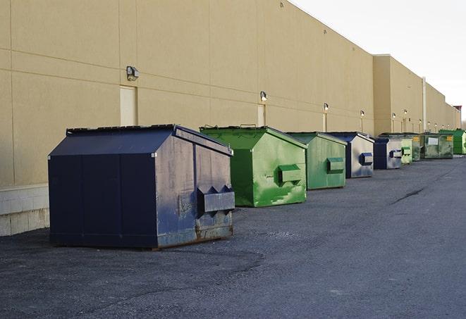 a row of heavy-duty dumpsters ready for use at a construction project in East Newark